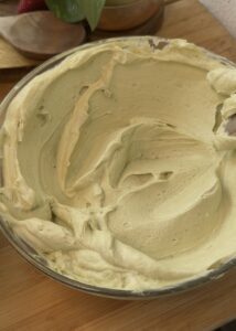 No bake pistachio cheesecake filling in a bowl, creamy and fluffy texture, pistachio flavor, easy no-bake cheesecake recipe