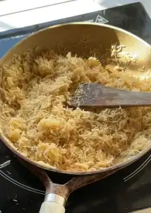 Toasting kataifi in a pan with melted butter, creating a golden and crunchy filling for desserts