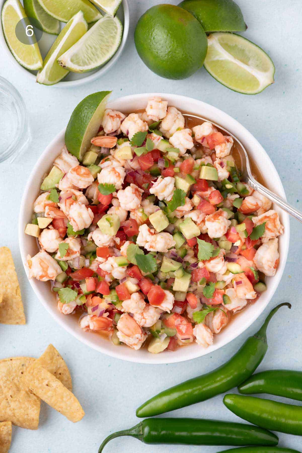 Finished shrimp ceviche recipe with avocado, tomato, lime, and tortilla chips