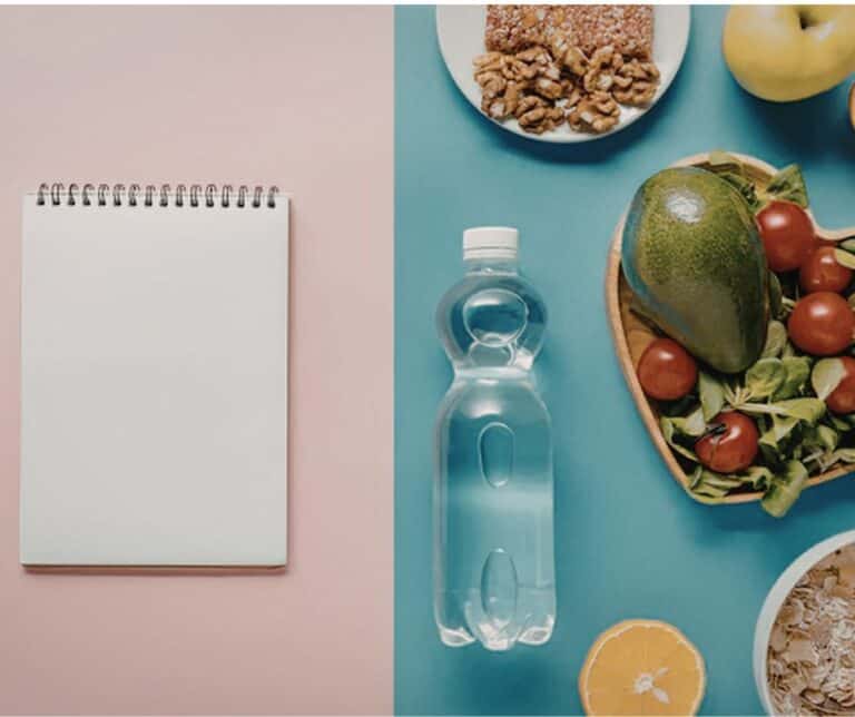 Bottle of water and good nutrition next to a note pad