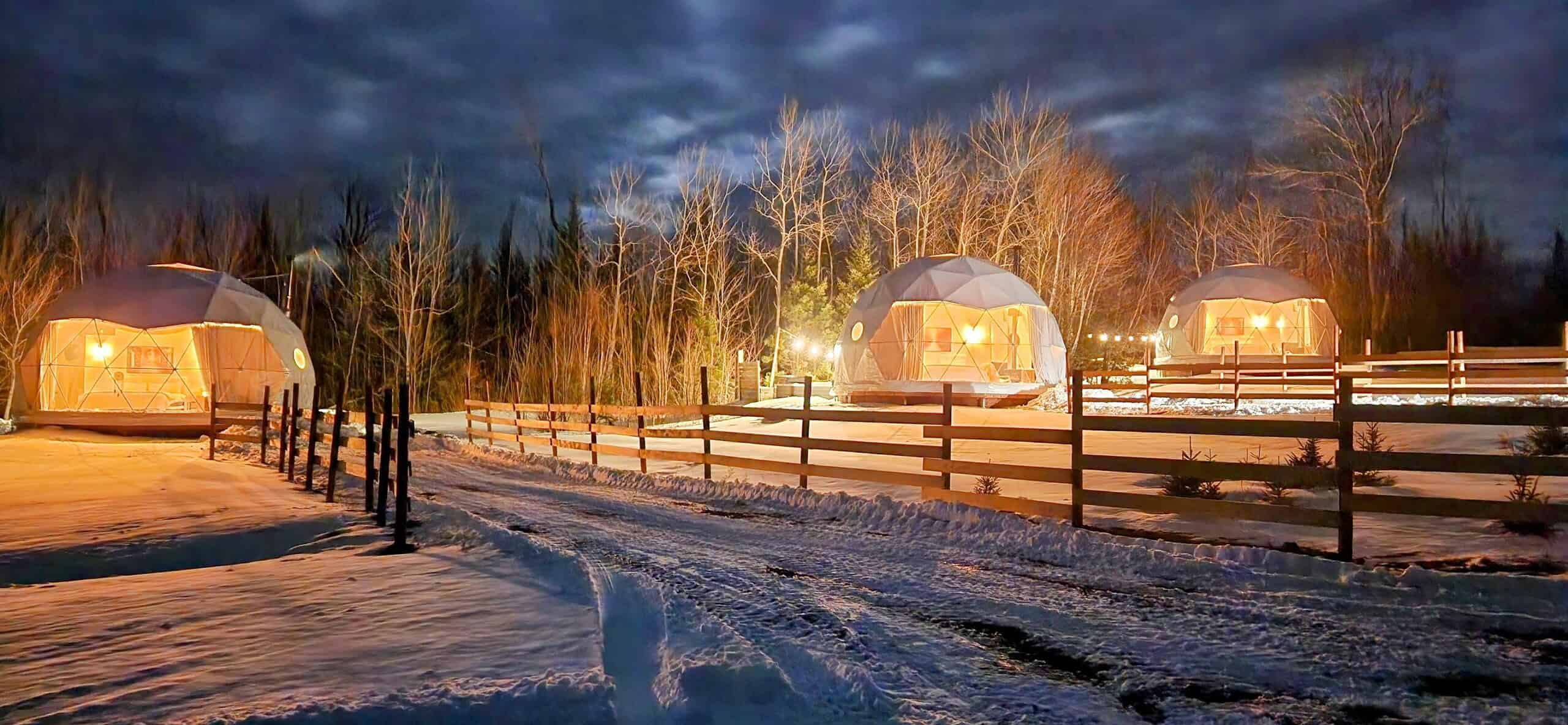 The Wallace River Range and Domes lit up at night. Nova Scotia glamping domes.