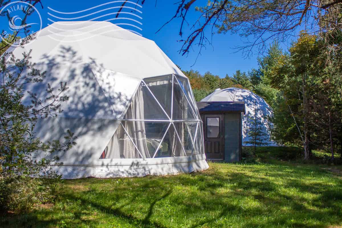 Two glamping domes nestled in the woods at As the River bend Retreats.  Nova Scotia glamping domes.