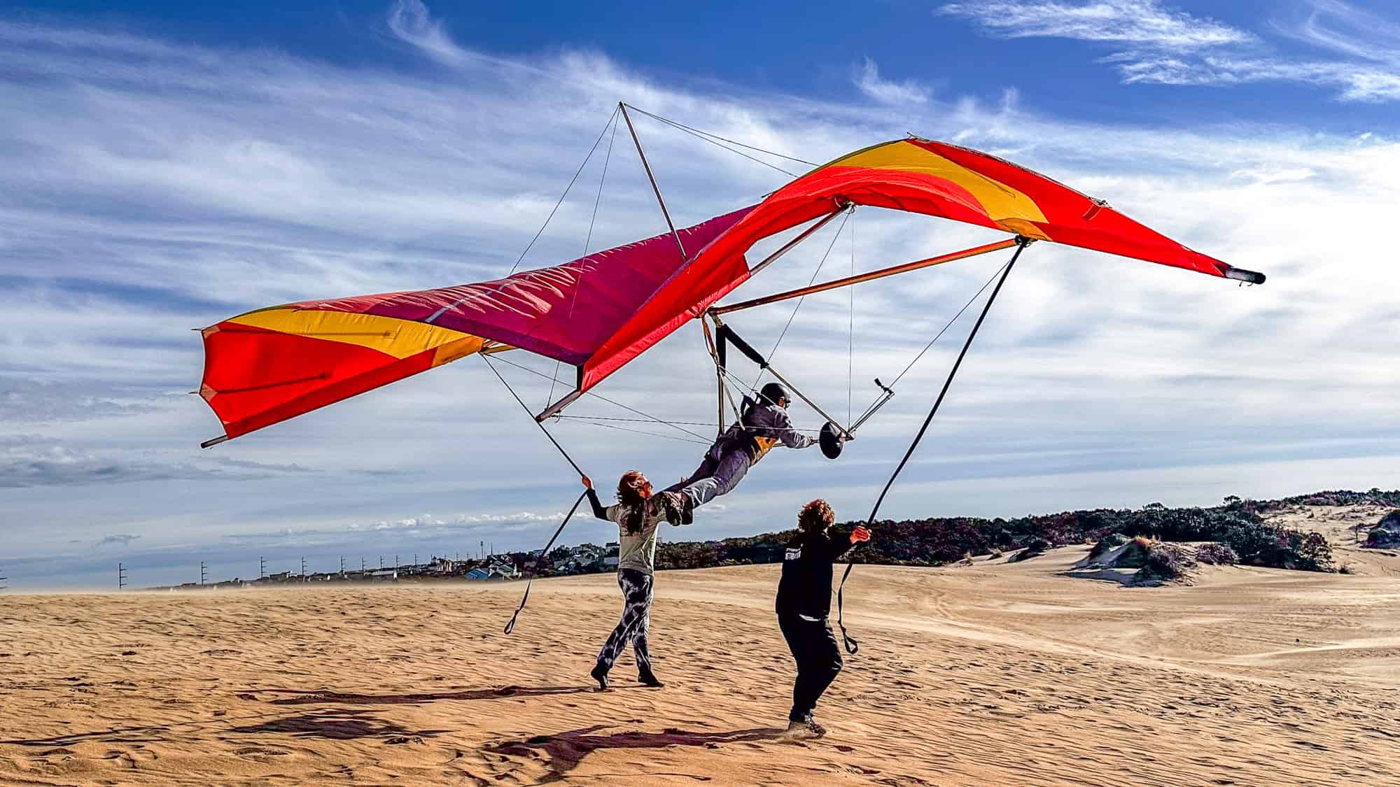 I am the pilot and am hang gliding in the outer banks with two instructors on either side of the hang glider.