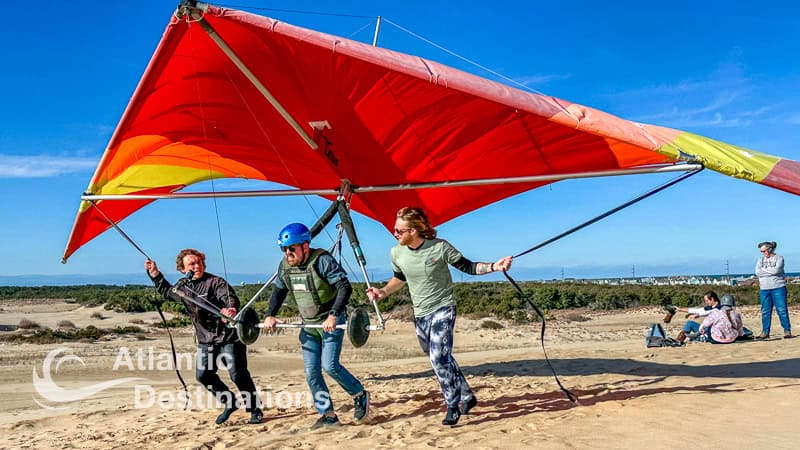 Enjoy a fun-filled day at the beach with friends windsurfing and flying a colorful sail, capturing the essence of coastal outdoor activities and seaside recreation.