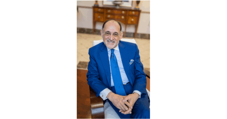 Michael Shellenberger smiling in a blue suit at Atomic Insights event.