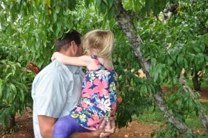 Picking peaches in purple cast.
