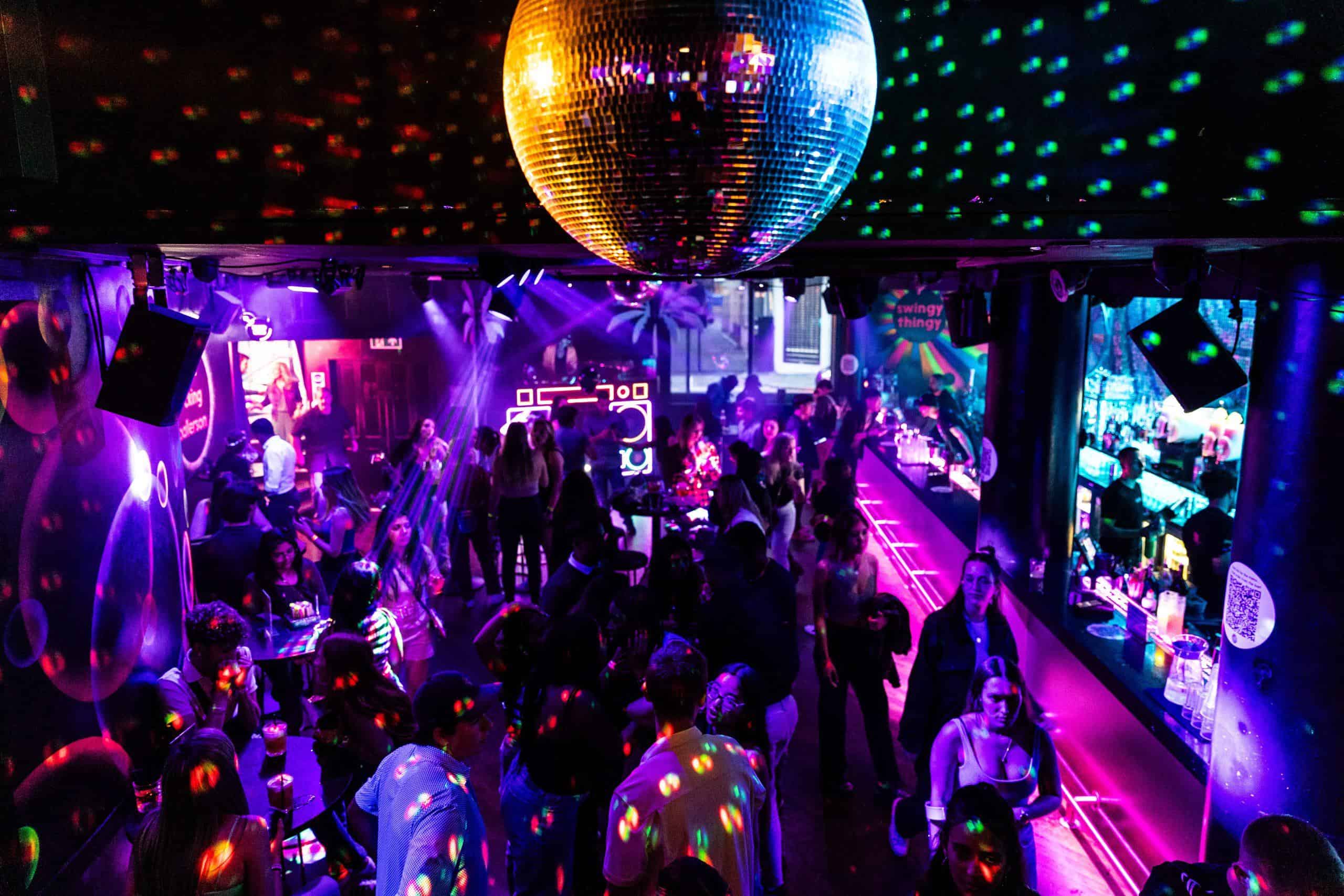 Vibrant ball pit with colourful LED lighting at Ballie Ballerson, a popular London nightlife and entertainment venue.