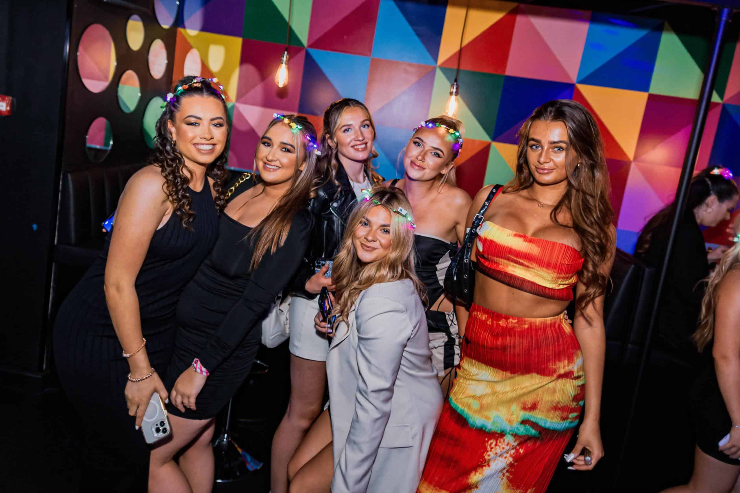 Vibrant group of women enjoying a fun night at Ballie Ballerson with colourful ball pits and lively atmosphere in London.