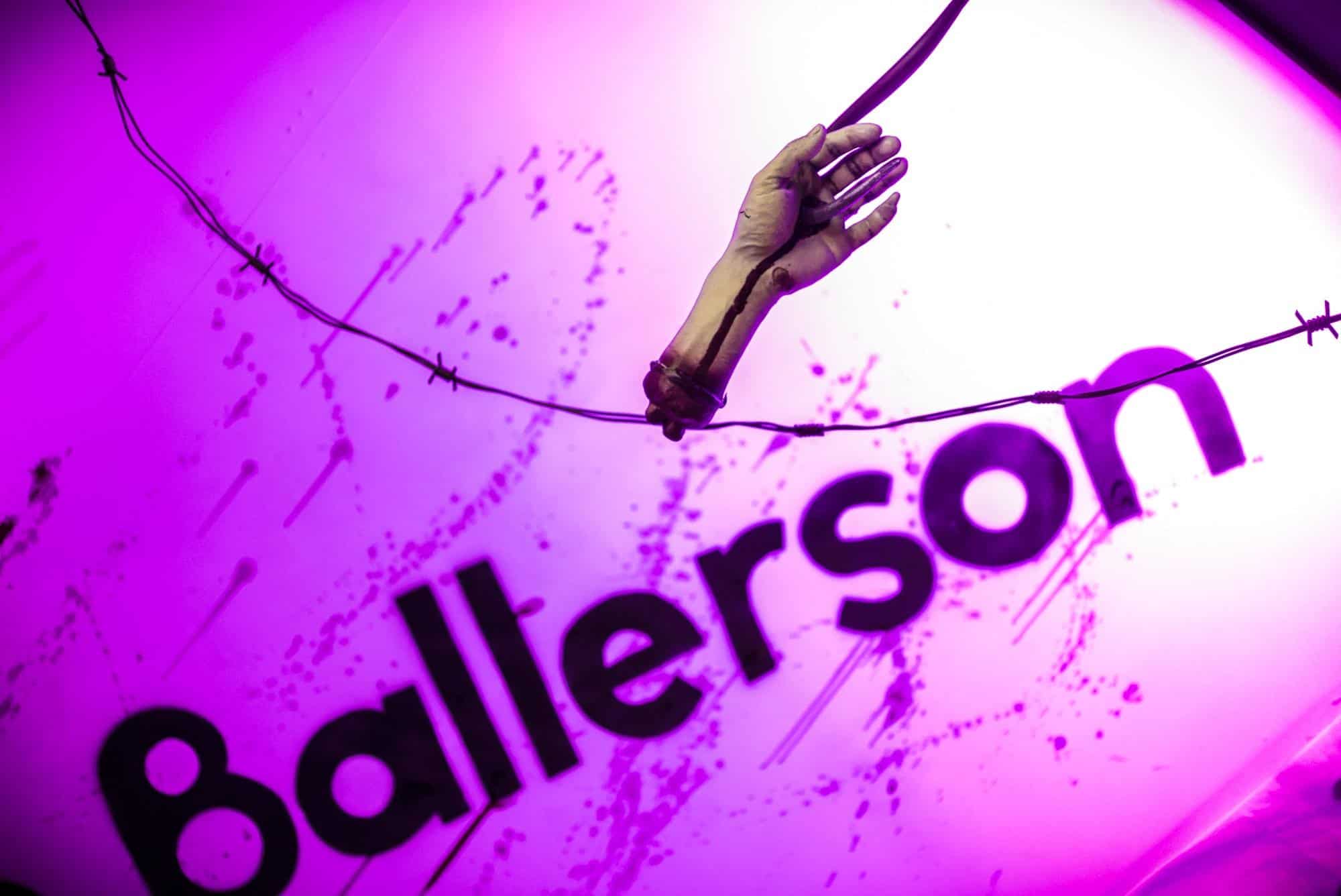 Vibrant pink and purple illuminated sign at Ballie Ballerson, renowned adult ball pit bar in Shoreditch.