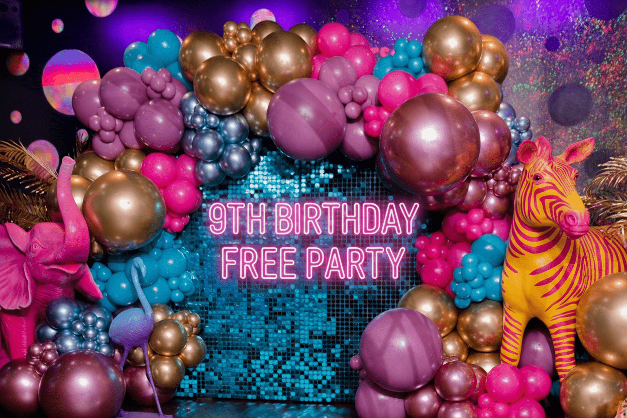 a group of friends drinking prosecco, one man is holding a birthday cake with sparklers sticking out of the top