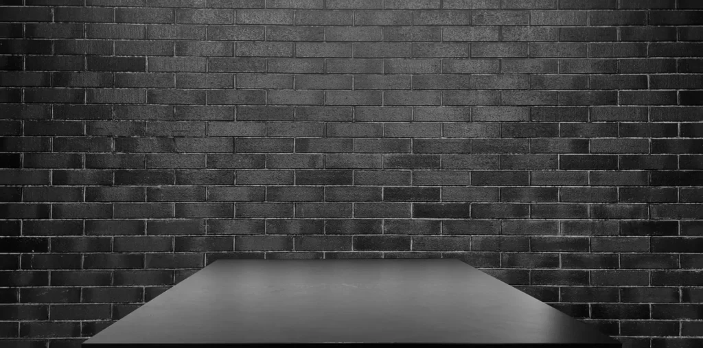 Top 10 Interior Design Mistakes That Cost Homeowners More 2 Interior design with black brick wall and table.