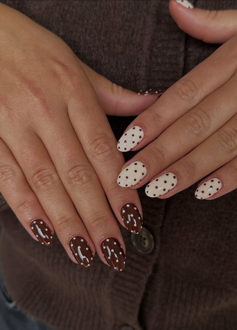 Chocolate and white nails paired with playful polka dots give cosy-cool energy. 