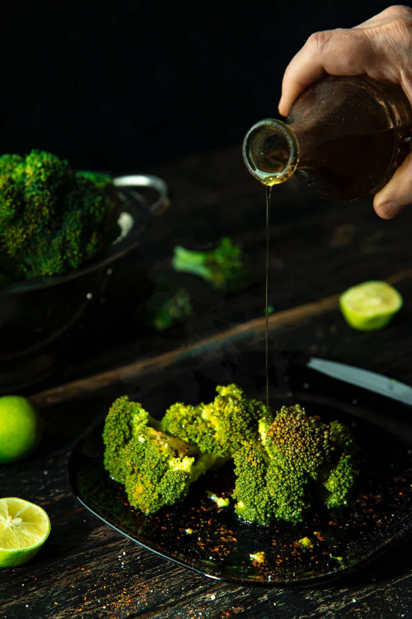 Oil being drizzled on broccoli