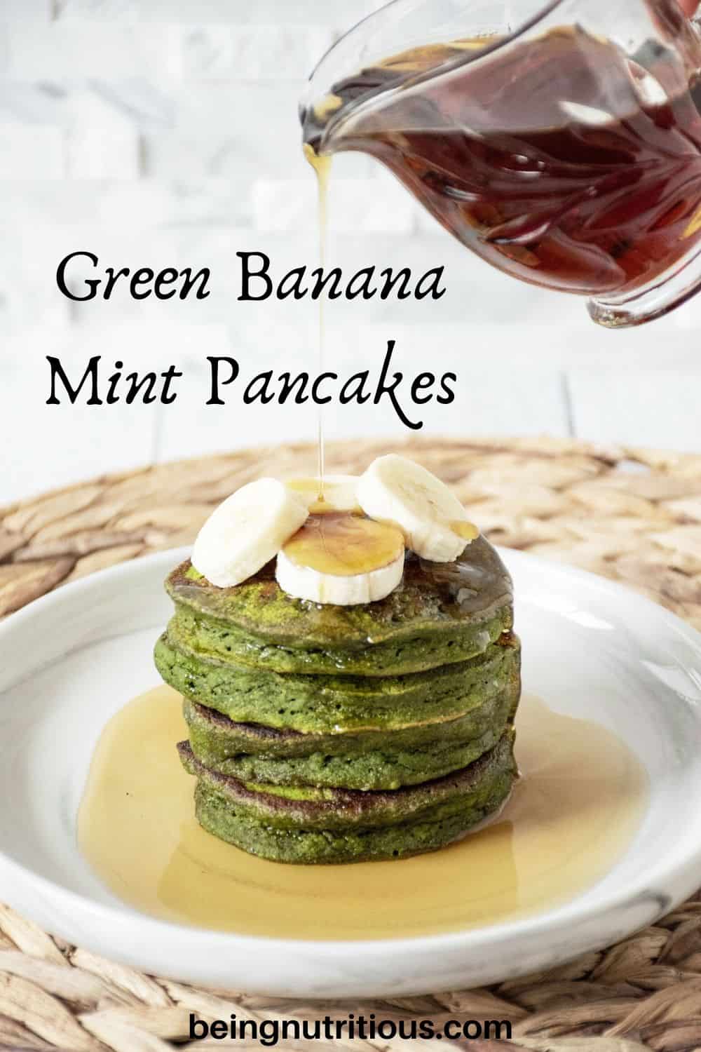 Banana Mint Pancakes on a plate, with banana slices on top, being drizzled with syrup