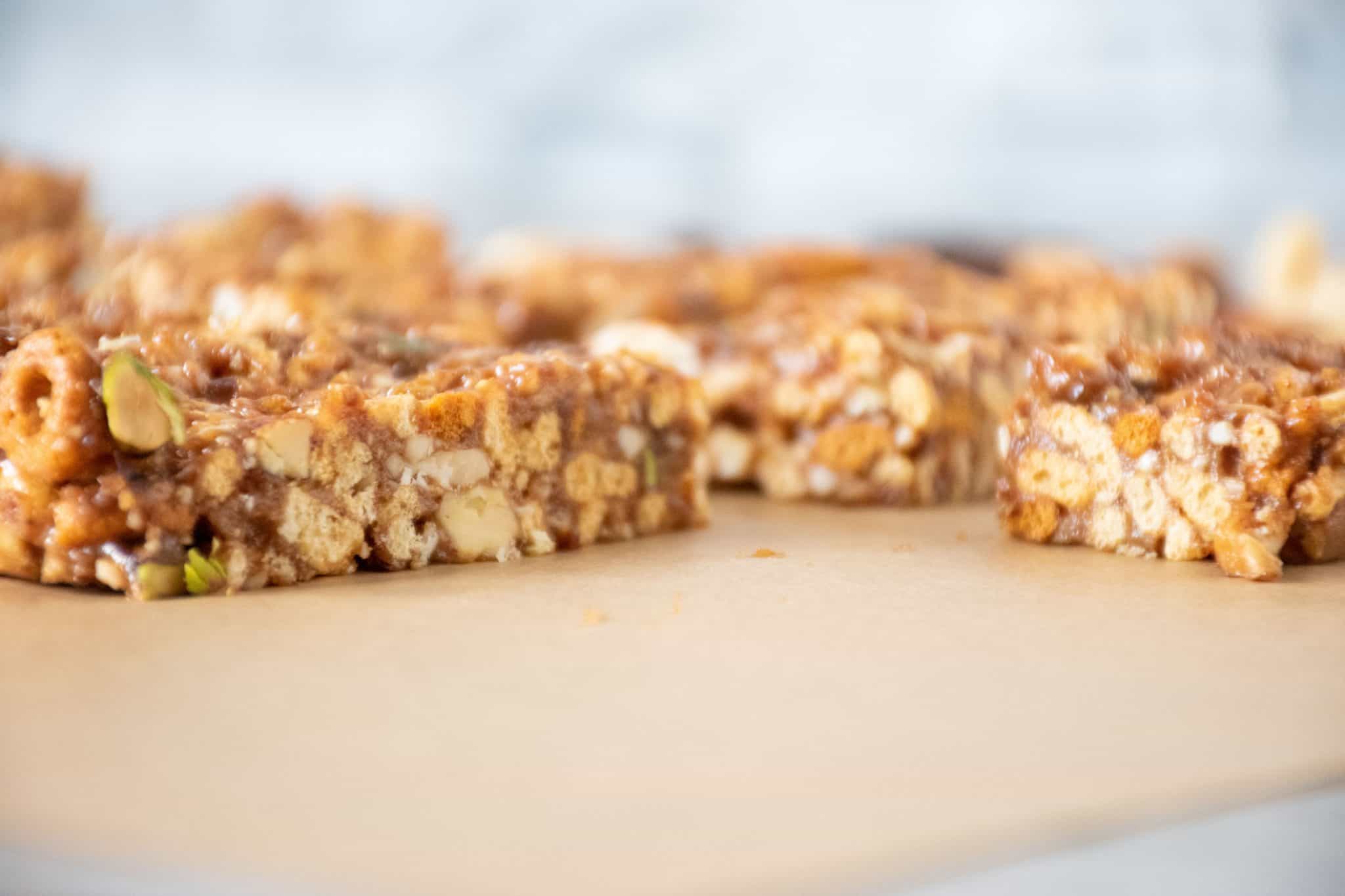 Close up of the side of cereal bars, on parchment paper.