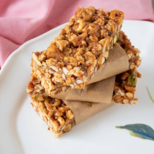 Stack of 4 cereal bars on a plate.