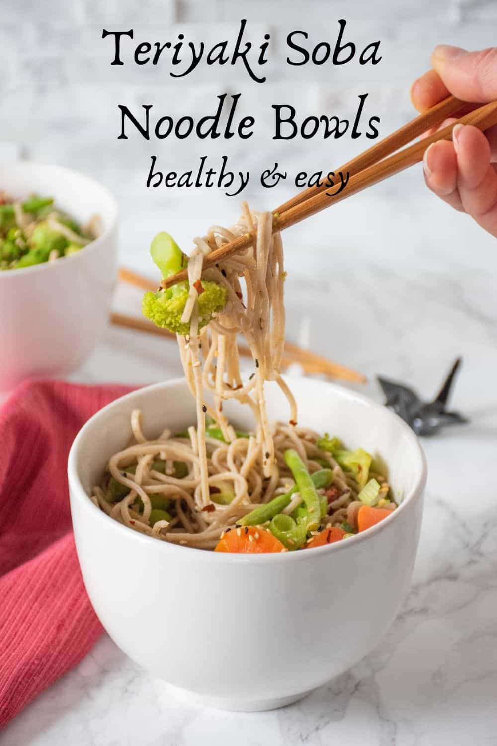 Teriyaki Soba noodles being lifted out of bowl with chopsticks