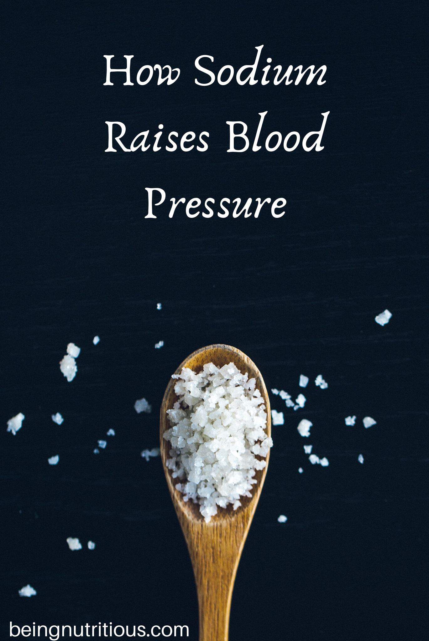 Wooden spoon filled with salt, on a black background