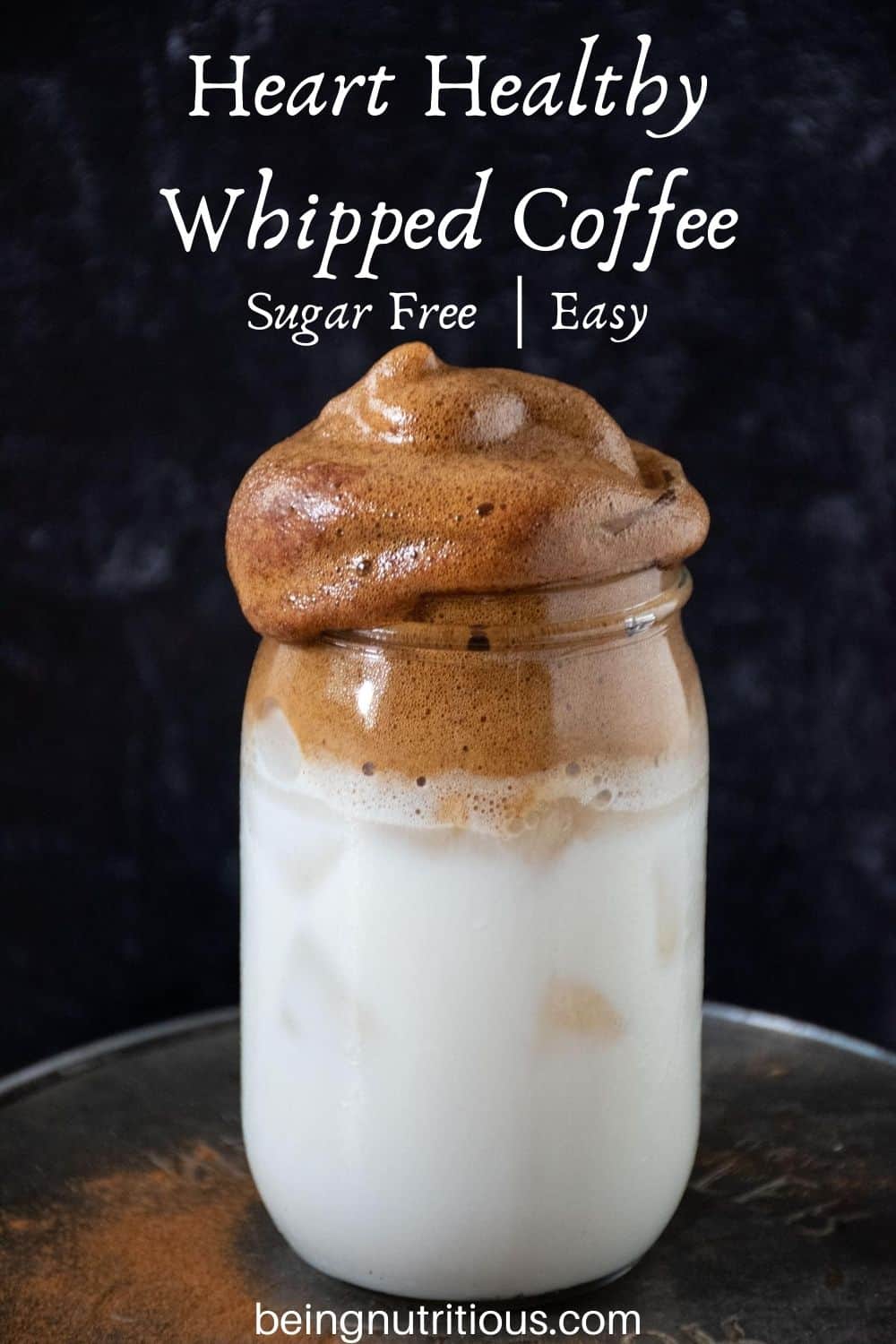 Whipped coffee over iced almond milk in a Mason jar with text overlay: &quote;Heart Healthy Whipped Coffee, sugar free; easy"