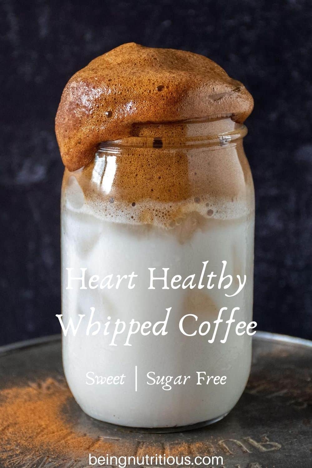 Whipped coffee over iced almond milk in a Mason jar with text overlay: "Heart Healthy Whipped Coffee, sweet; sugar free"