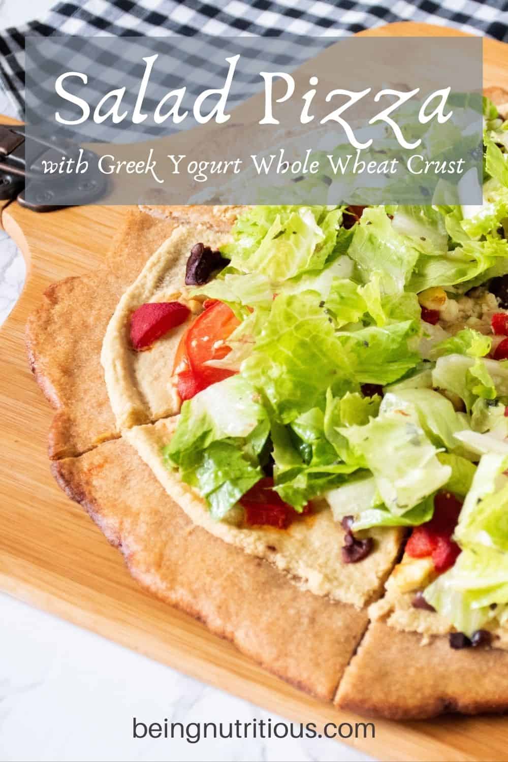 Pizza on a peel, with whole wheat crust, topped with salad. Text overlay: Salad Pizza with Greek Yogurt Whole Wheat Crust.