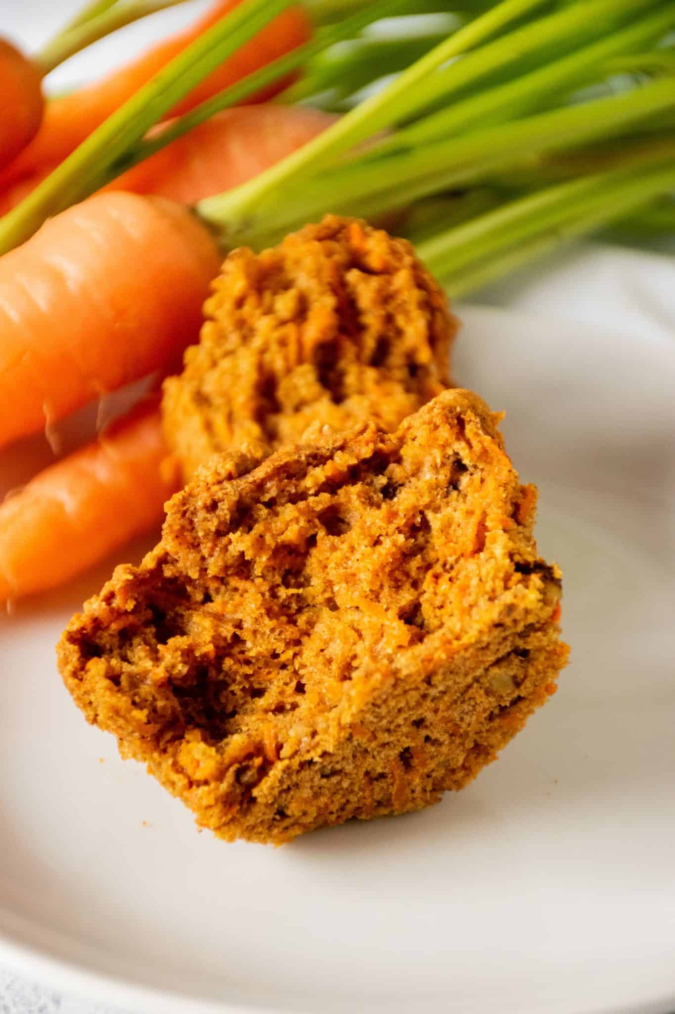 Muffin on a plate, cut in half.