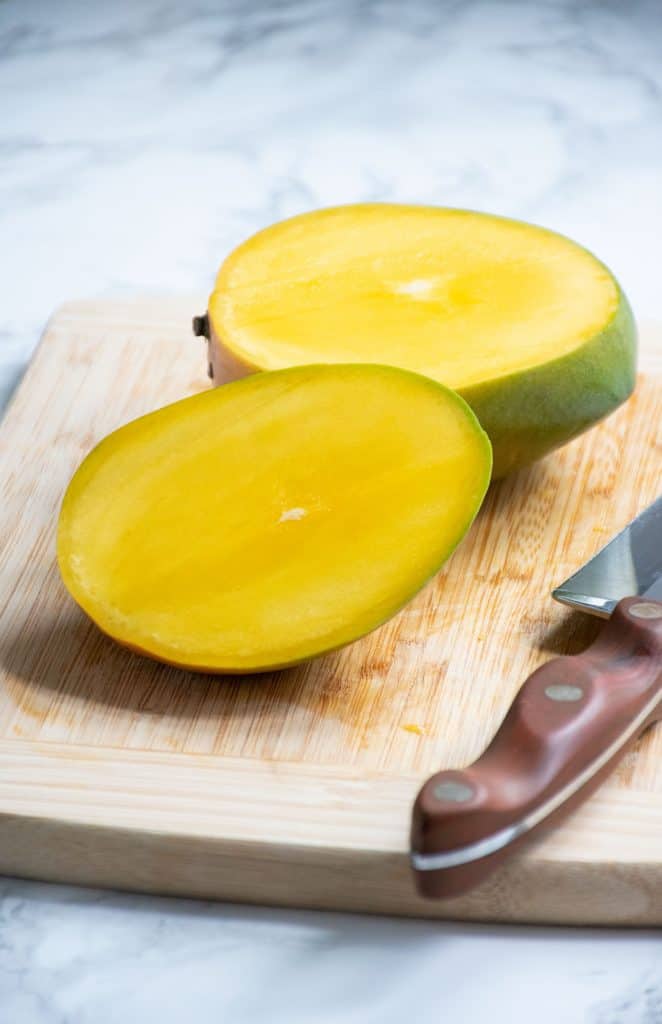 Whole mango, with one slice removed