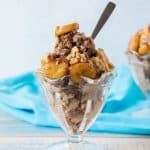 Sundae dish with nice cream topped with caramelized bananas and walnuts