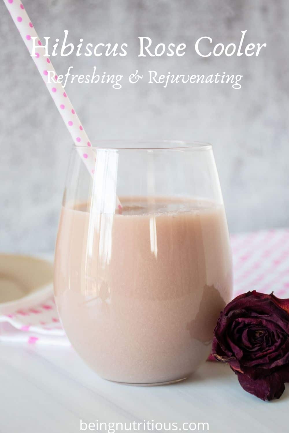 Glass of pink beverage. Text overlay: Hibiscus Rose Cooler; Refreshing & Rejuvenating.