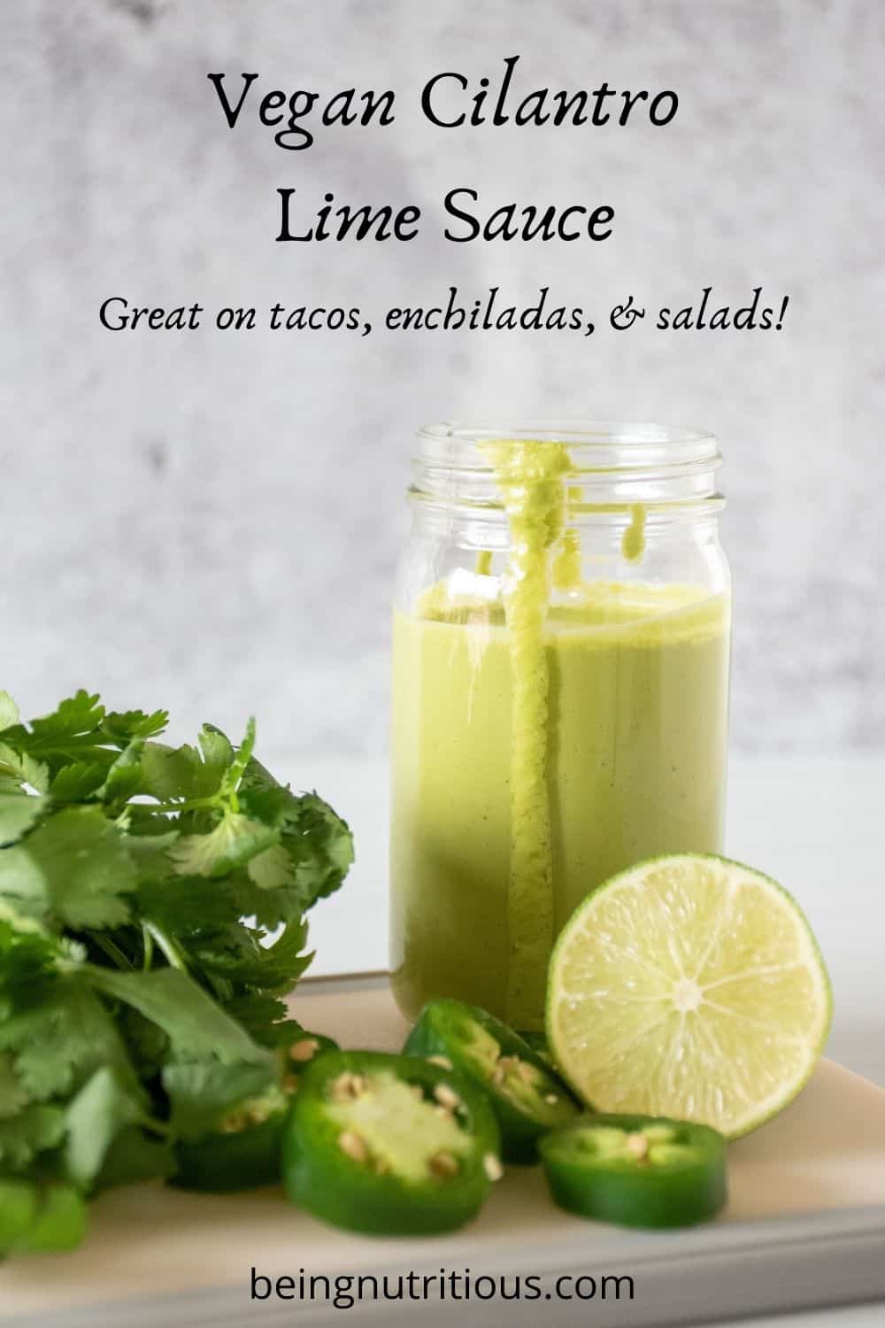 Small jar of green sauce, with ingredients around it. Text overlay: Vegan Cilantro Lime Sauce. Great on tacos, enchiladas, and salads!