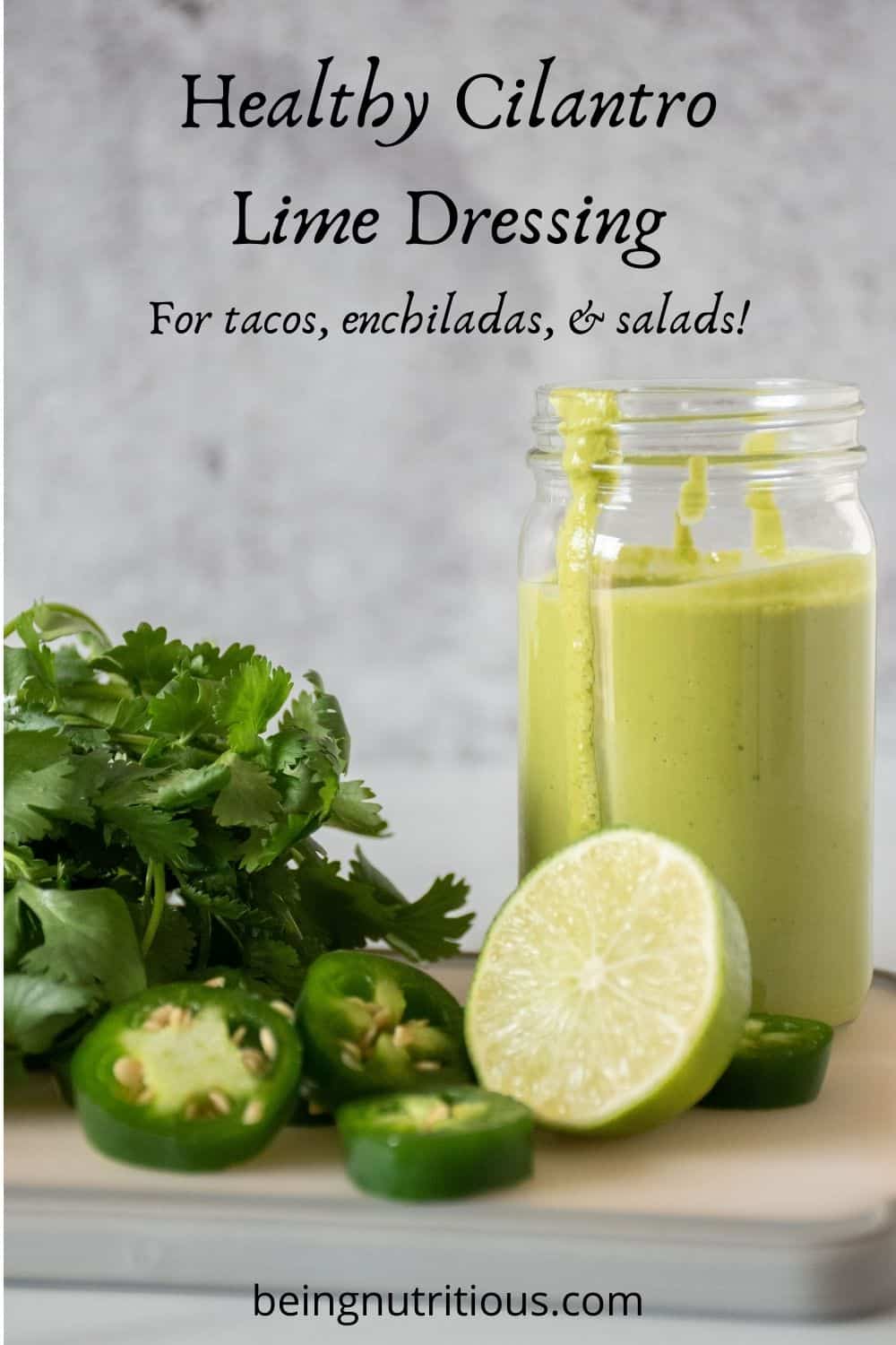 Small jar of green sauce, with ingredients around it. Text overlay: Healthy Cilantro Lime Dressing. For tacos, enchiladas, and salads!