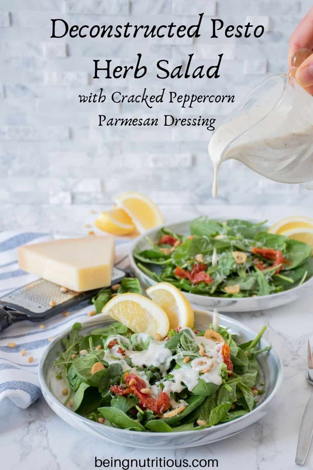 Plate of salad with sundried tomatoes, and fried garlic with dressing being drizzled over. Text overlay: Deconstructed Pesto Herb Salad with Cracked Peppercorn Parmesan Dressing