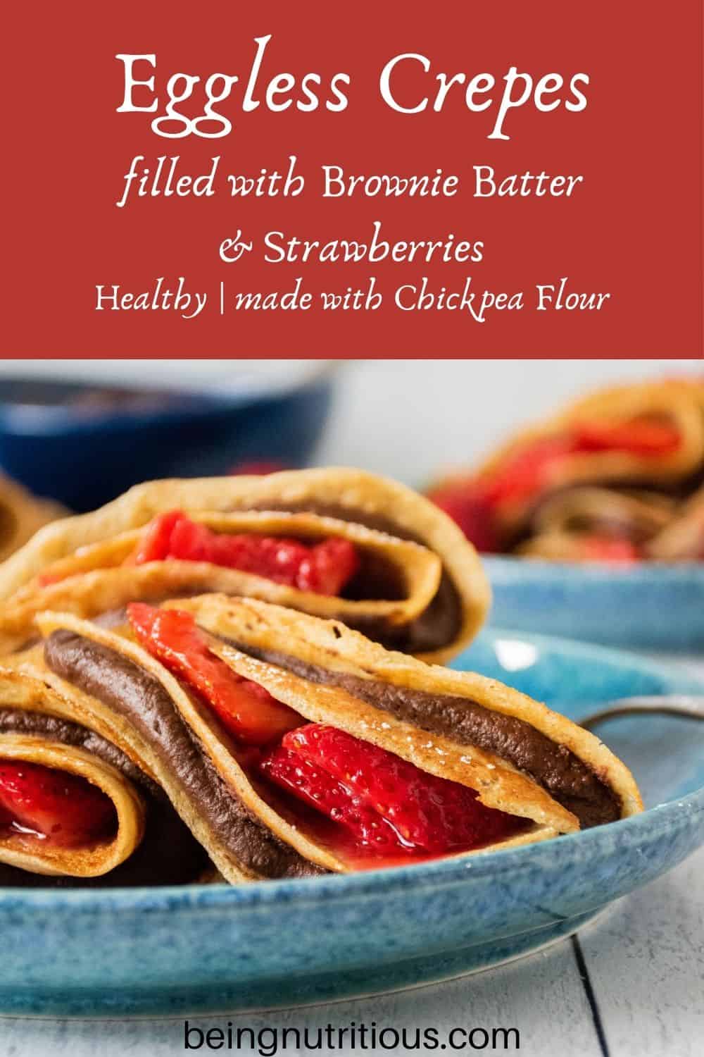 Plate of 3 crepes stuffed with chocolate dip and strawberries. Text overlay: Eggless Crepes filled with Brownie Batter and strawberries; Healthy, made with chickpea flour