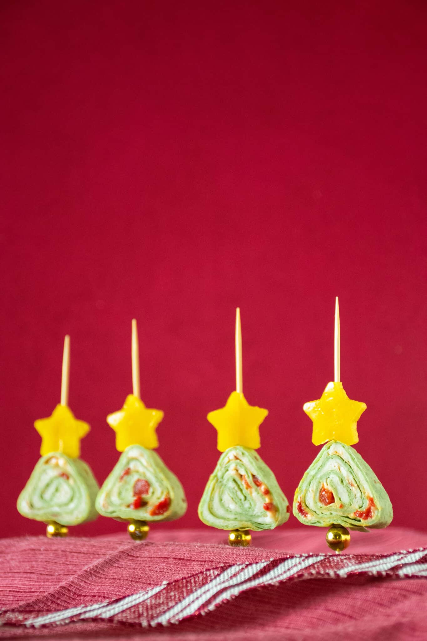Green tortilla roll up appetizers shaped like a Christmas tree.