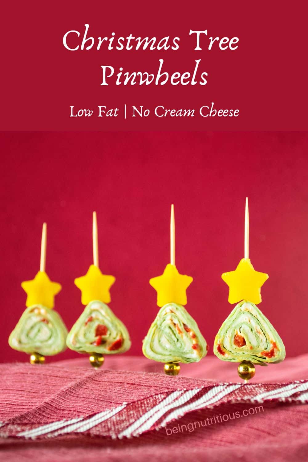 Green tortilla roll up appetizers shaped like a Christmas tree. Text overlay: Christmas tree pinwheels, low fat, no cream cheese.