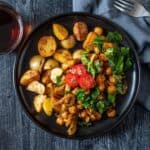 Overhead image of chickpea breakfast skillet on a plate, with breakfast potatoes.