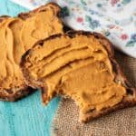 Two pieces of toast with a spread made of sweet potatoes and peanut butter.