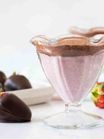 Dessert cup with strawberry and chocolate pudding in it.