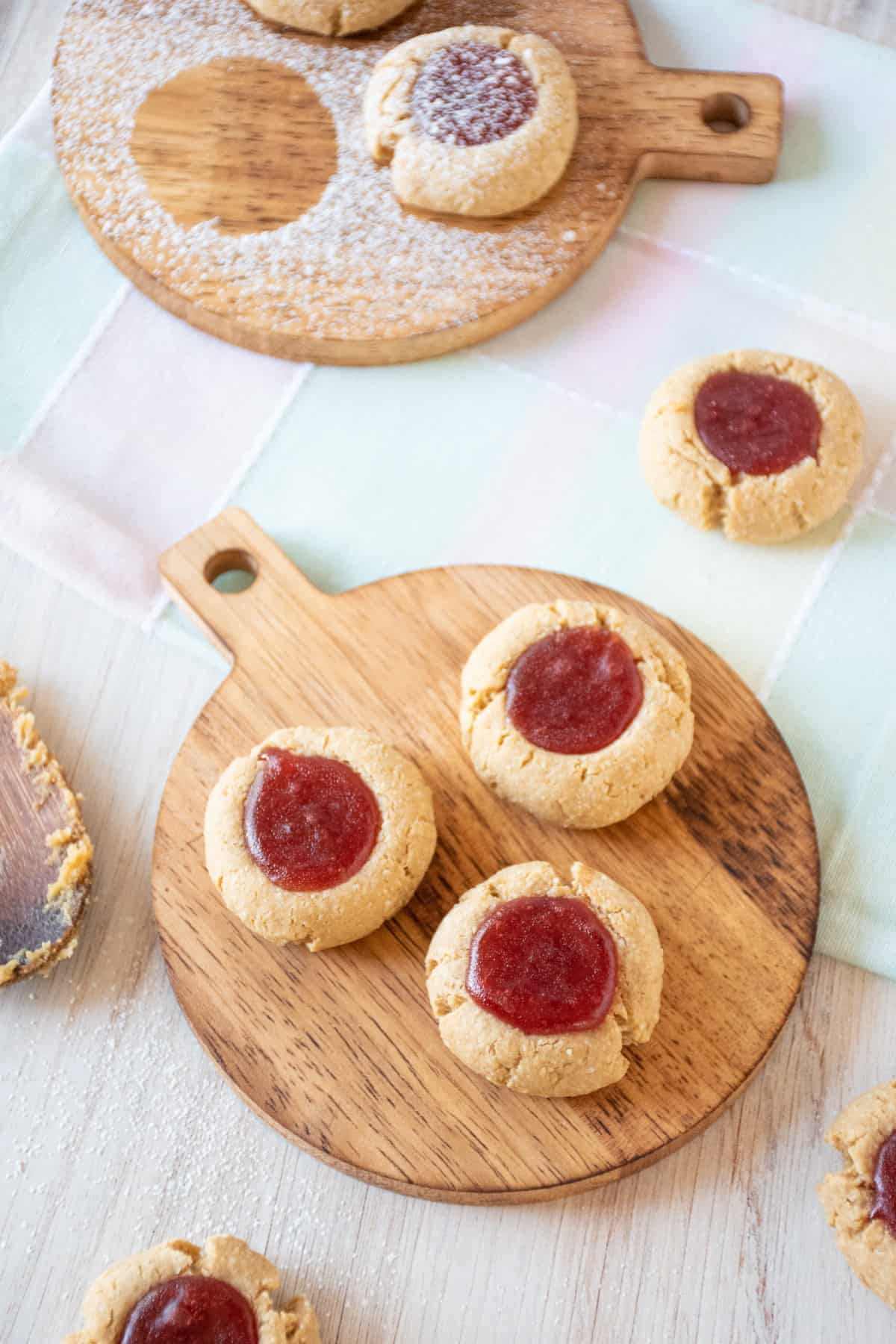 Three cookies on a wooden platter.