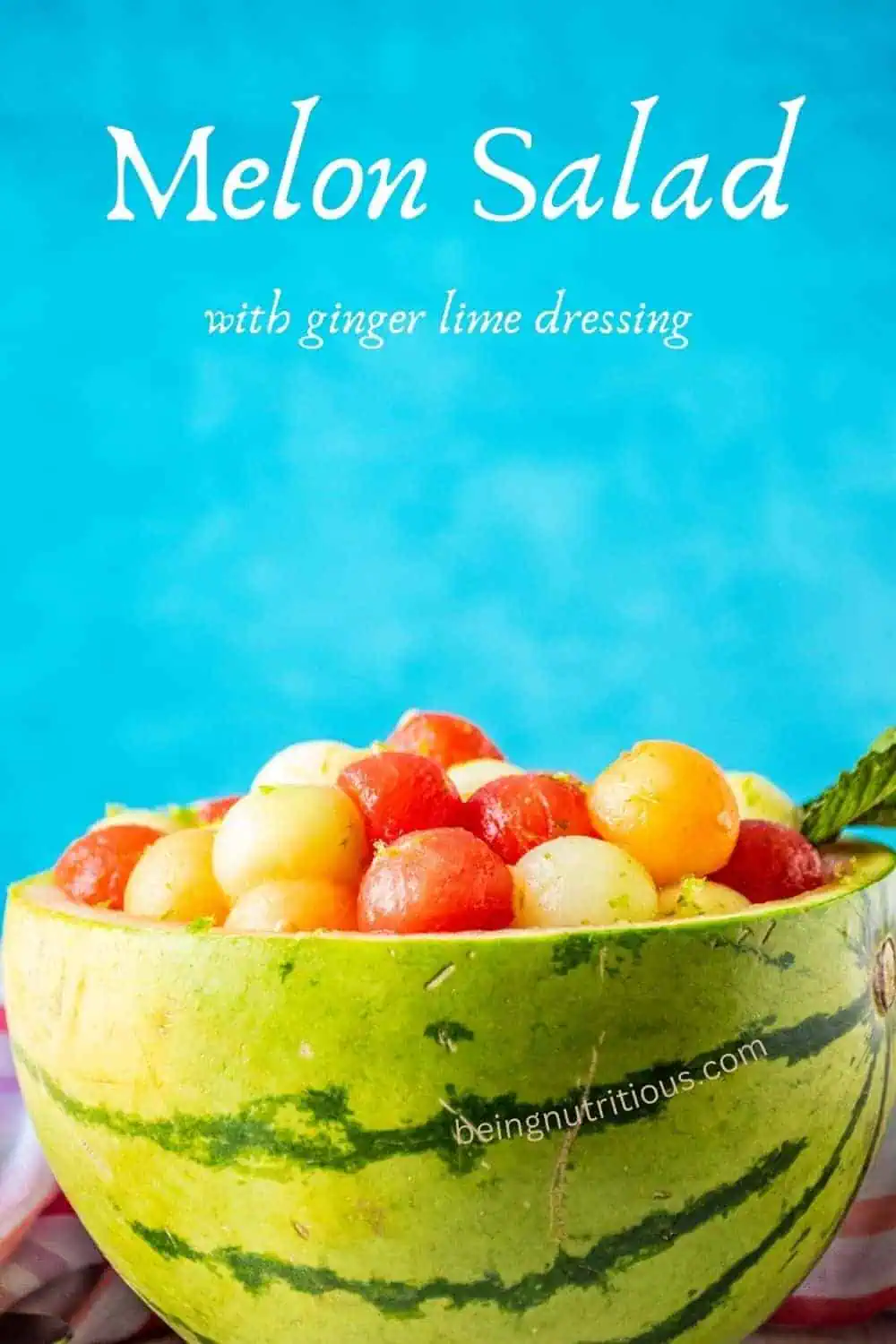 Balls of melon in a watermelon bowl. Text overlay: melon salad with ginger lime dressing.