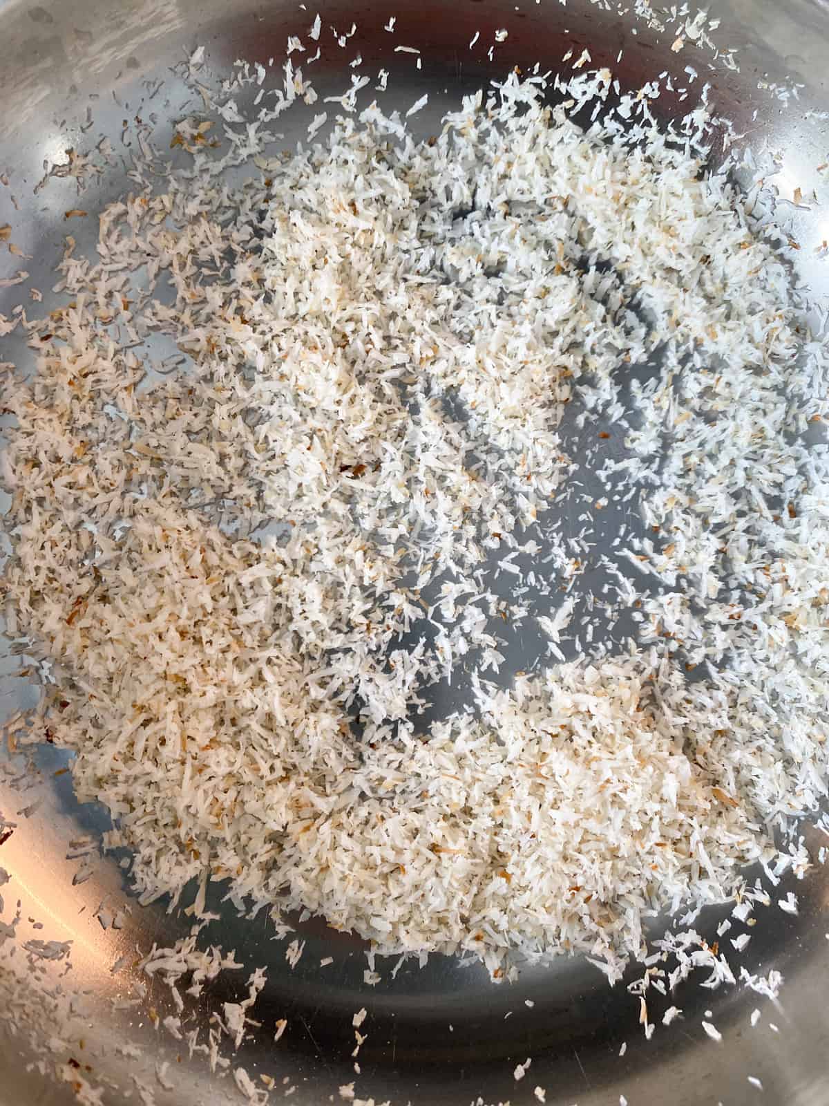 Coconut toasting in a pan.