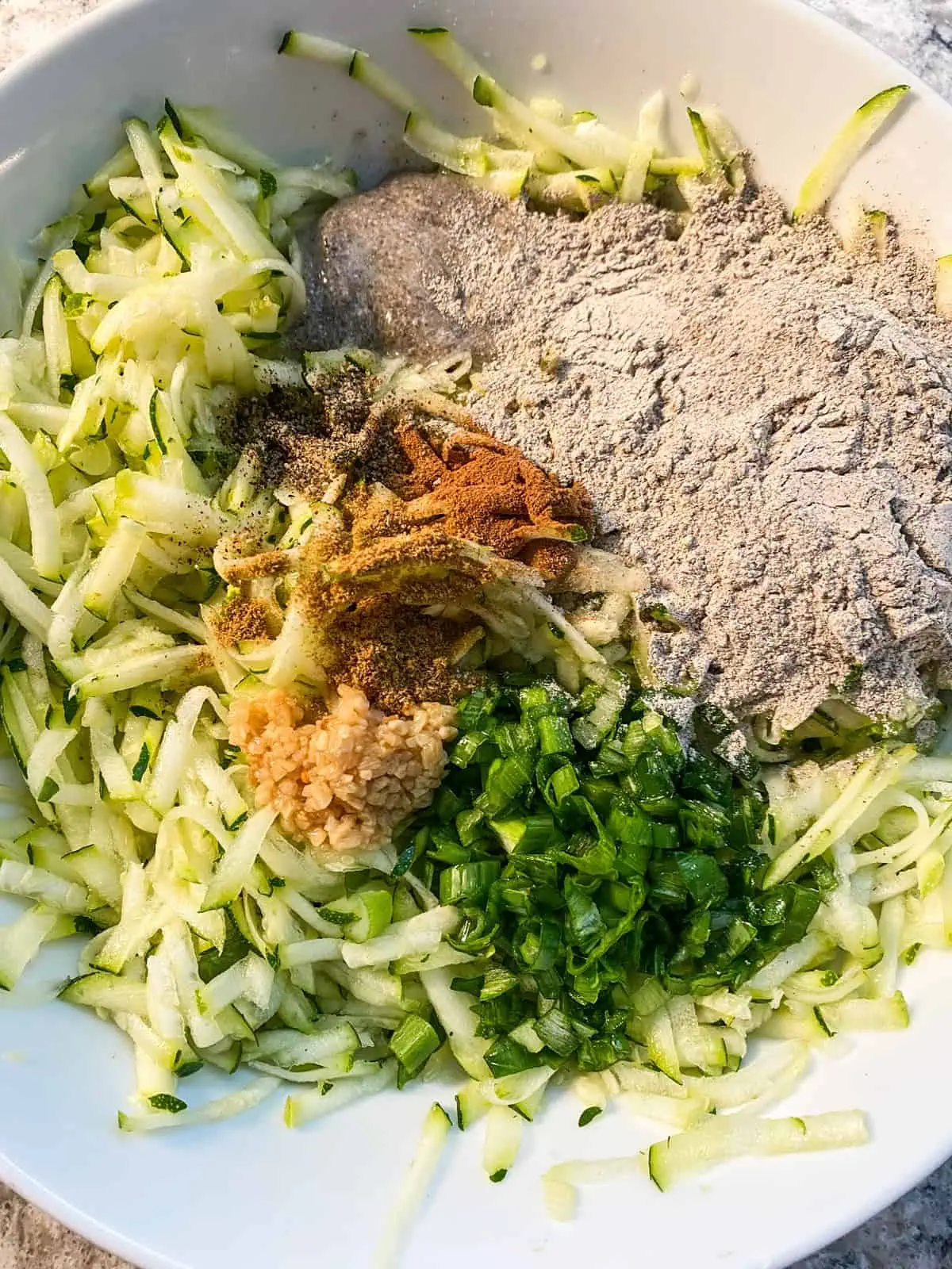 All ingredients for the fritters in a bowl.