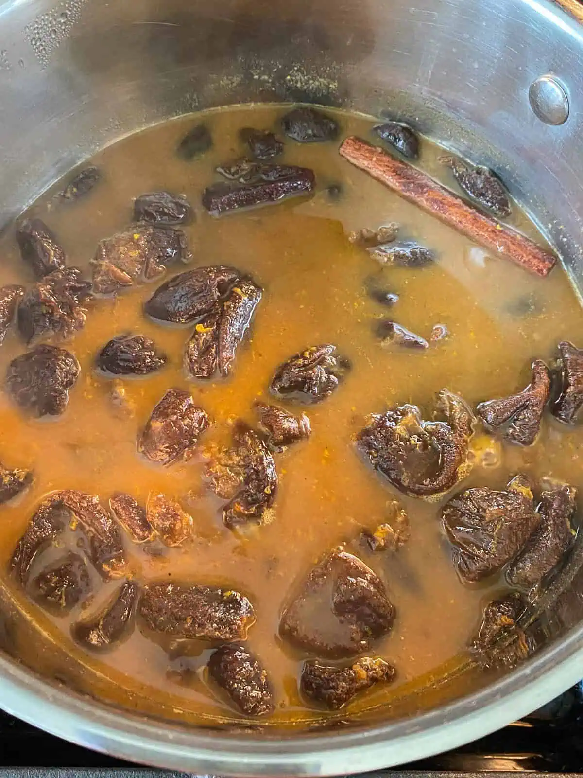 Pot with finished prune compote in it, after simmering.