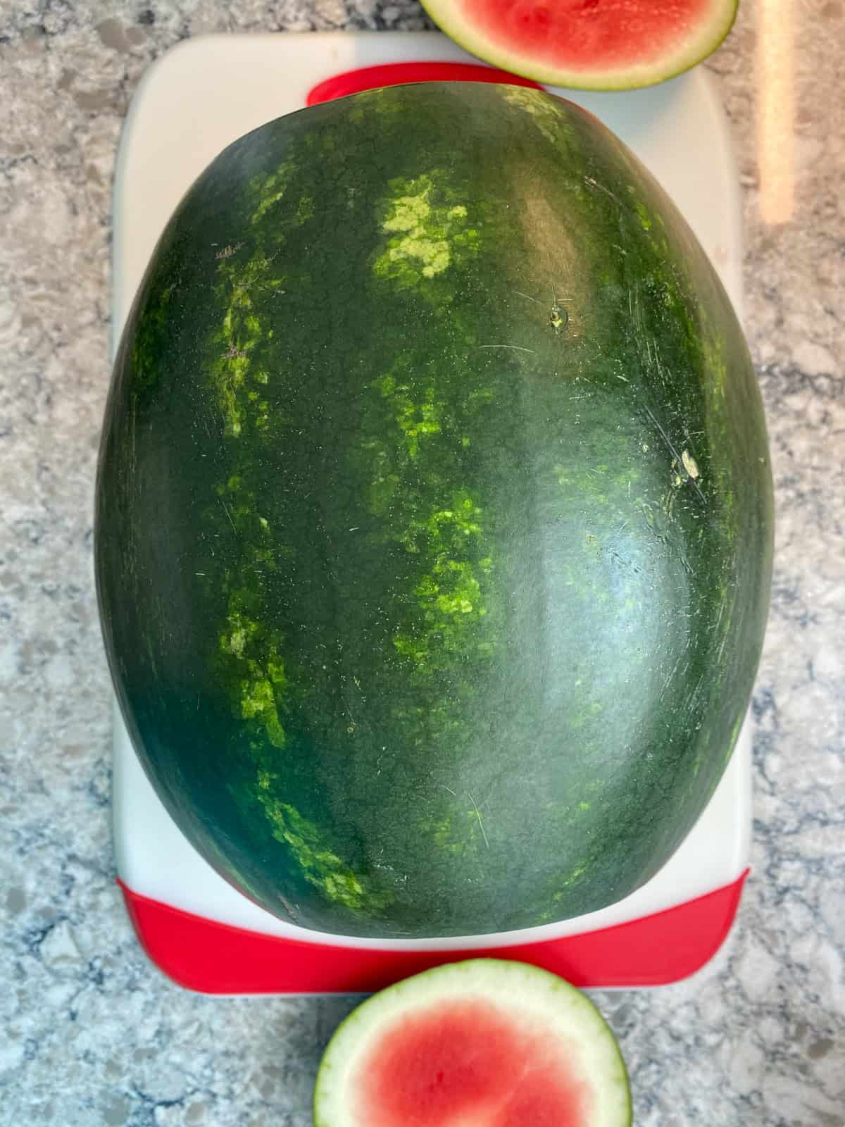 Whole watermelon with both ends sliced off.