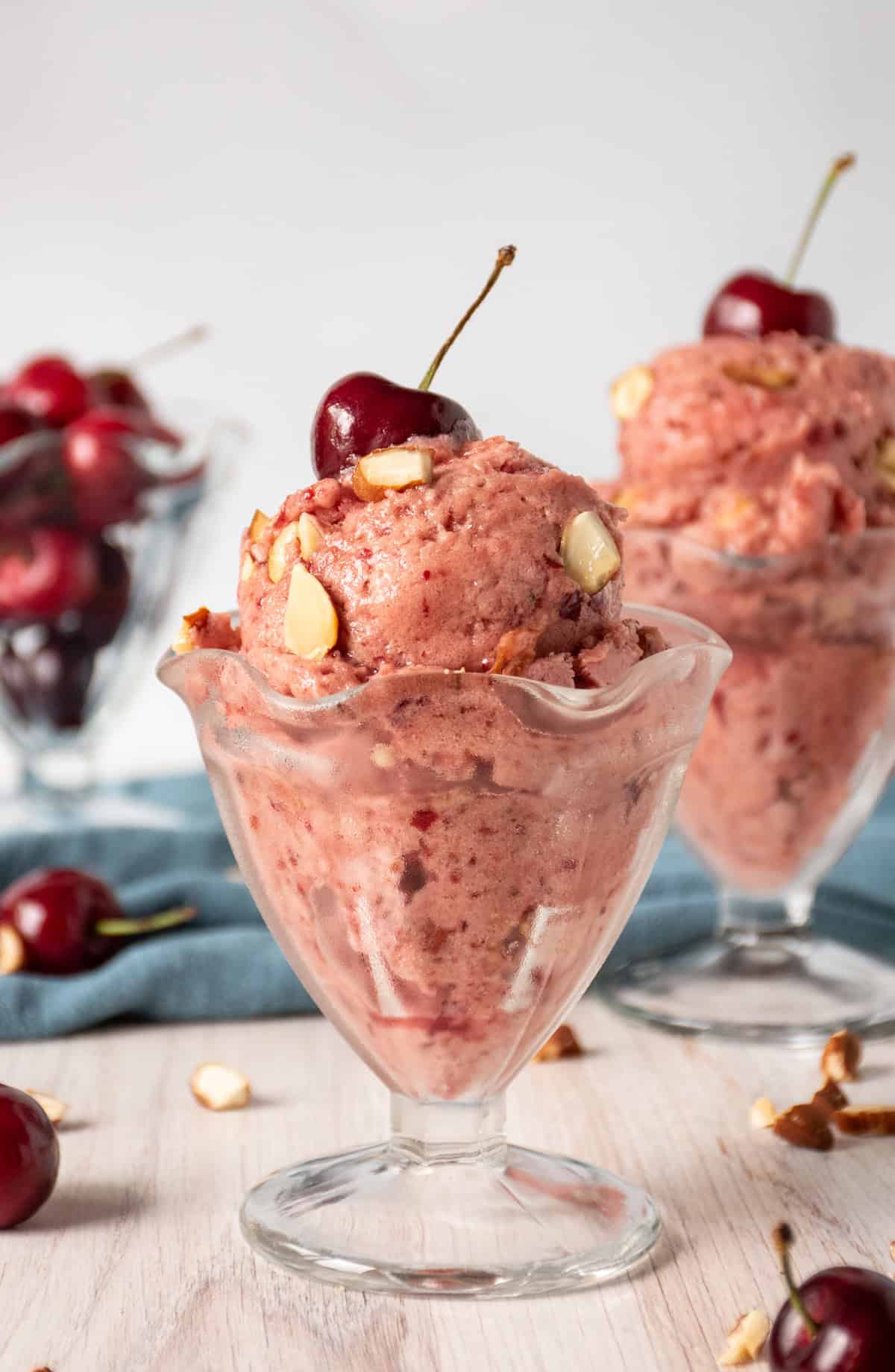 Two glass dishes of cherry ice cream.