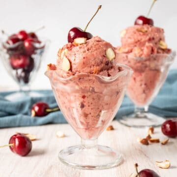 Two glass dishes of cherry ice cream.