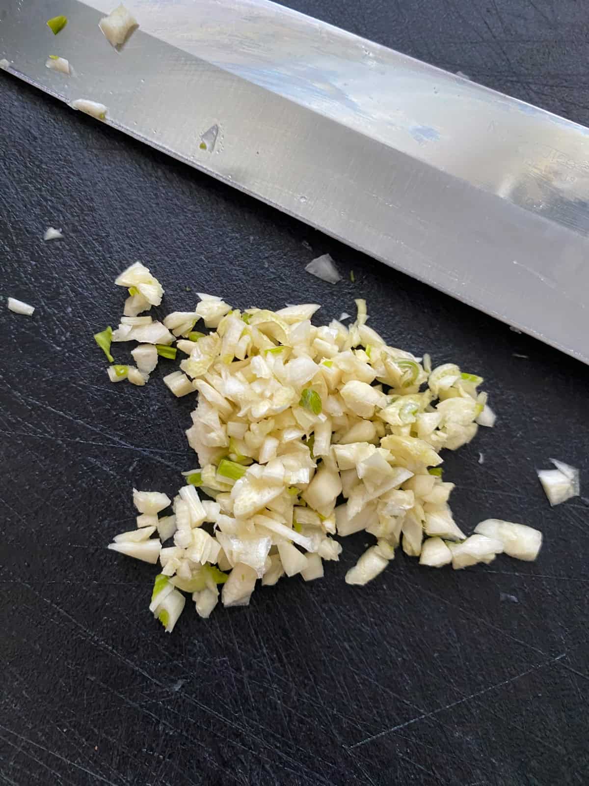 Minced garlic on a cutting board.