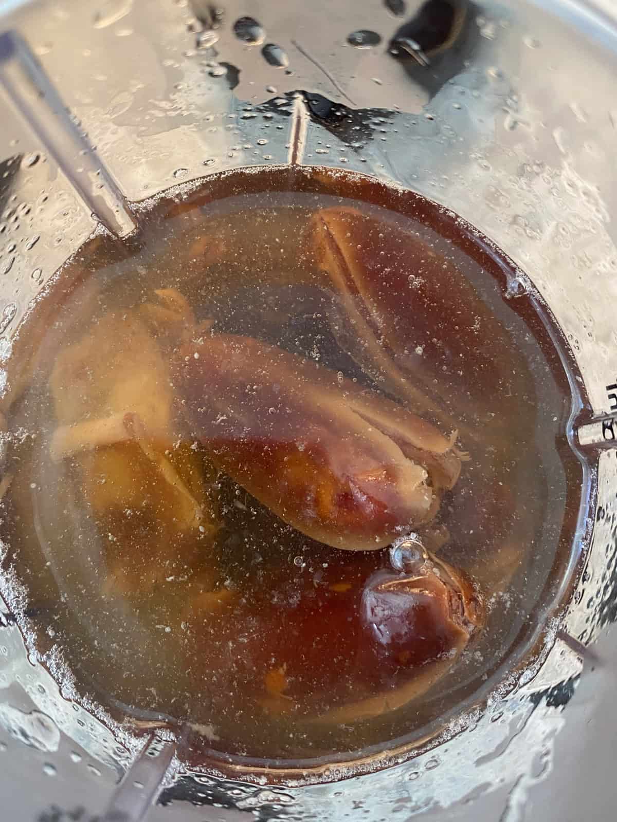Soaked, whole dates and water in a blender.
