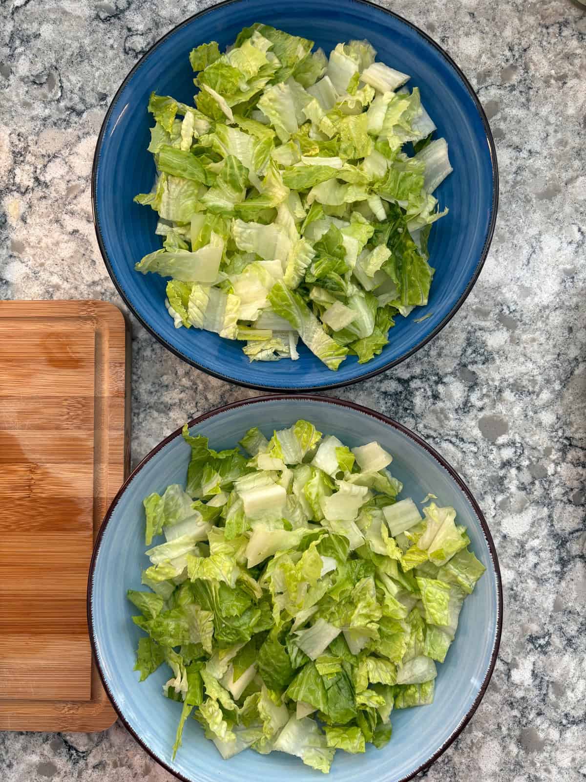 Chopped lettuce in salad bowls.
