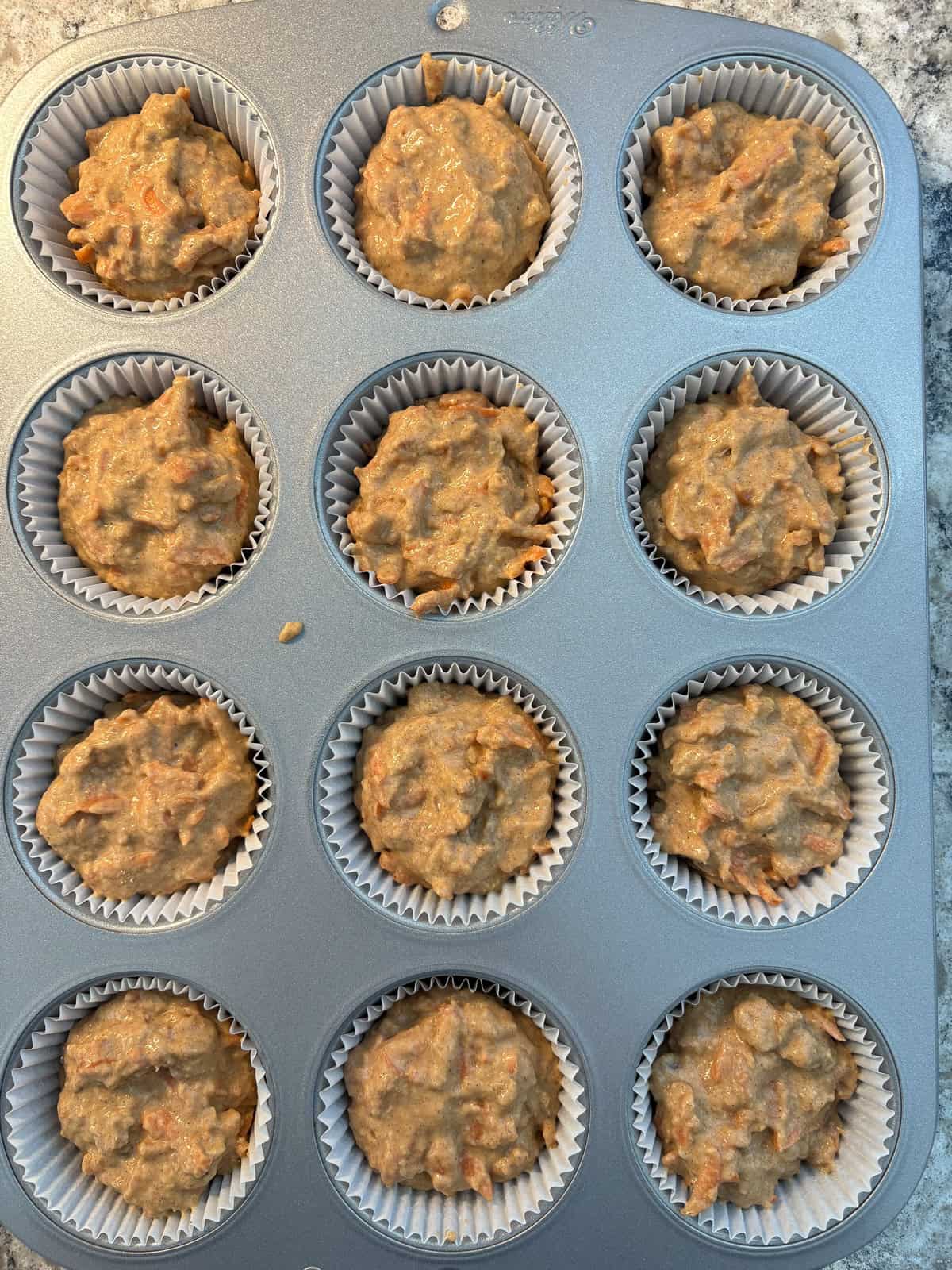 Muffin batter divided among 12 muffin cups.